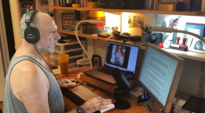 Leslie working alone in front of multiple computer monitors